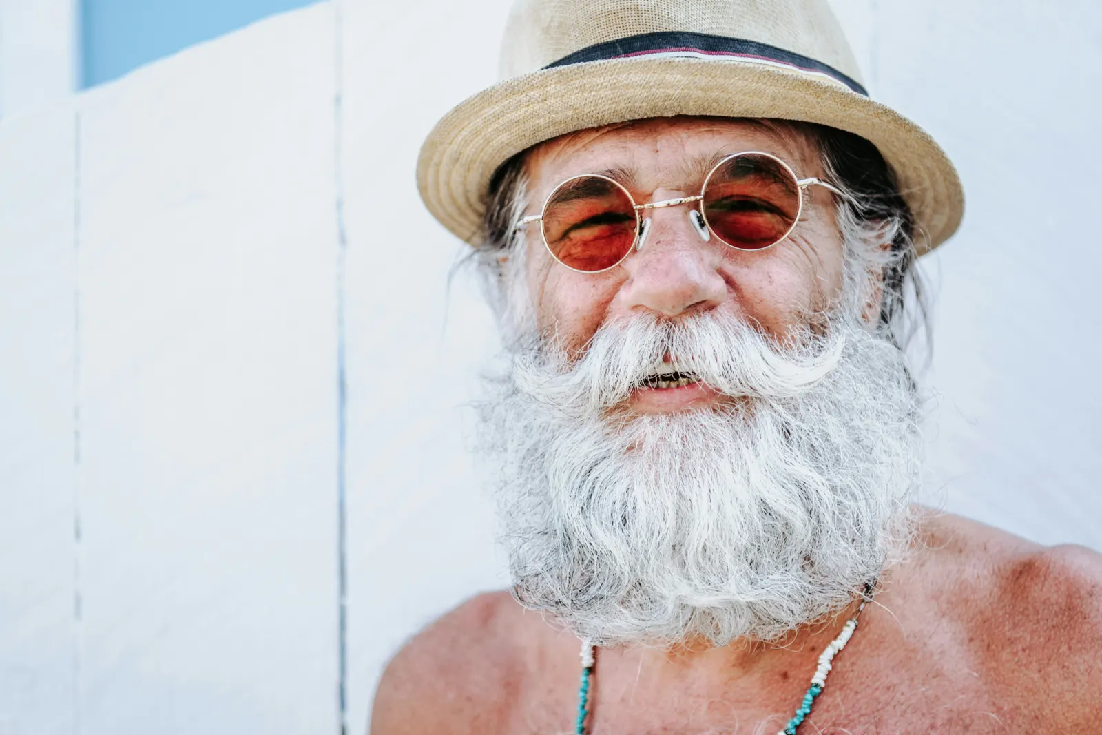 Smiling retired man in a straw hat
