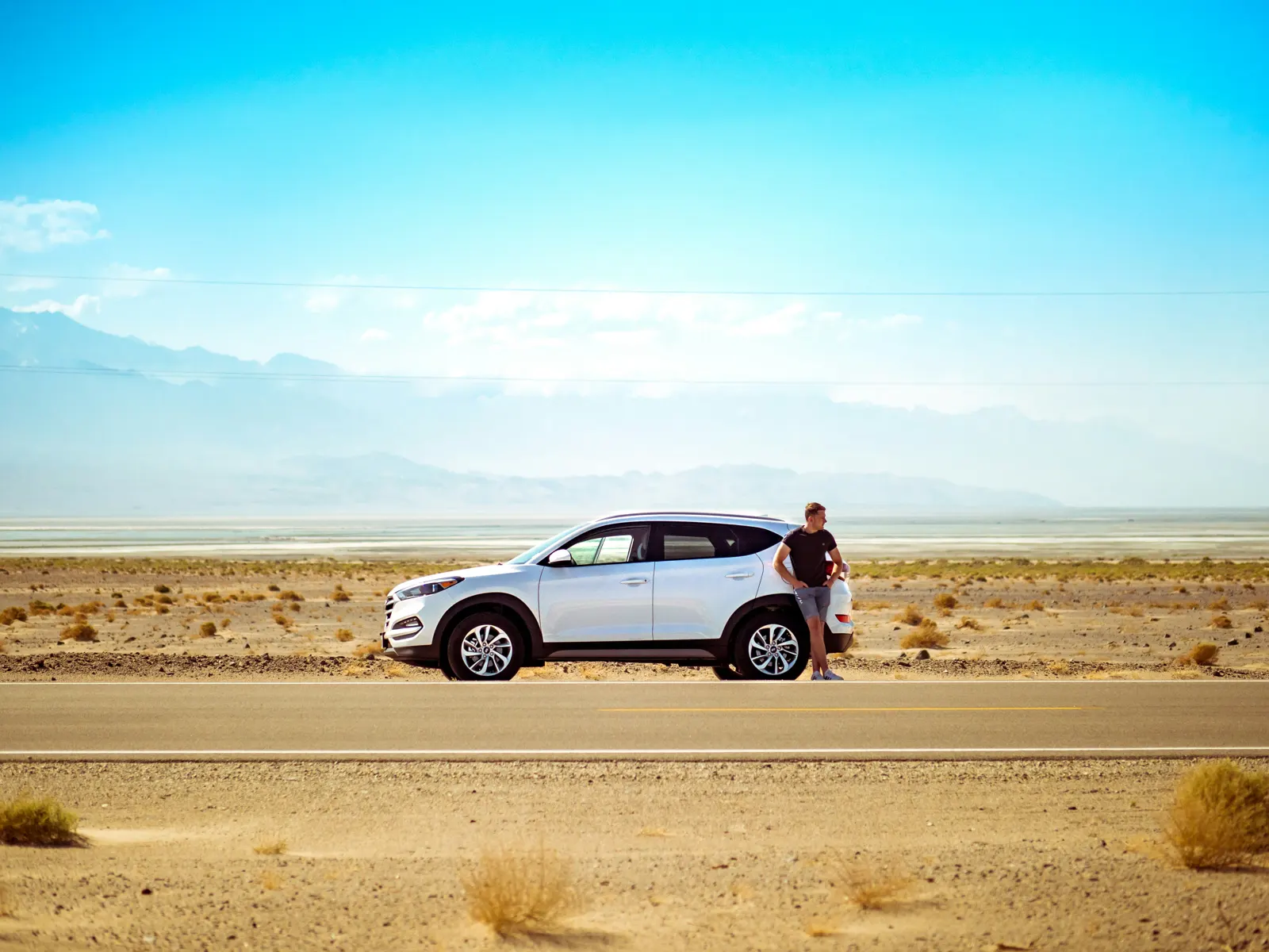 Car parked on an open desert road